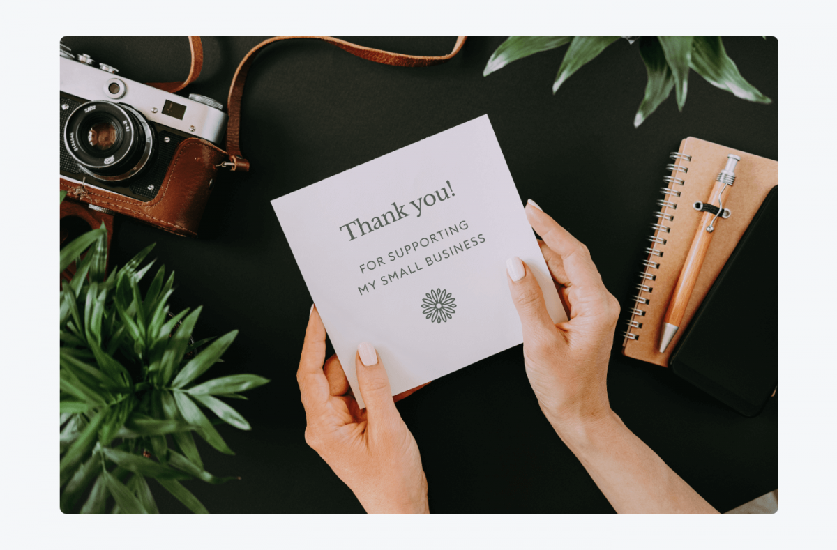 Female hands holding a card saying: Thank you! For supporting my small business